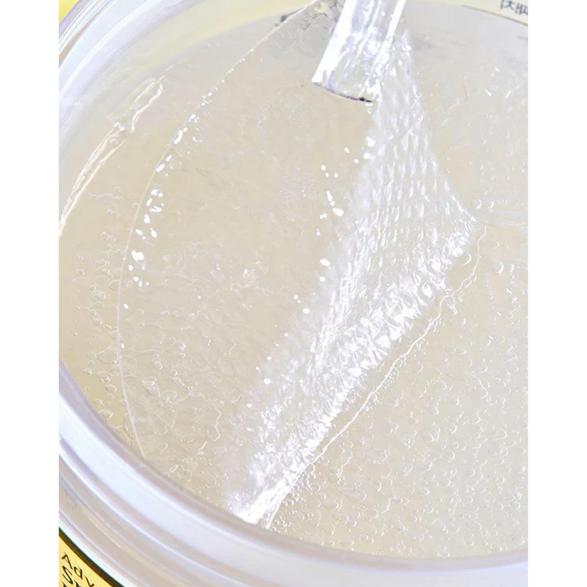 A close-up view of a jar of liquid soap, showcasing its smooth texture and inviting appearance.